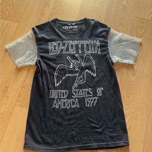 Woman’s Black Graphic Tee with Mesh Sleeves
v